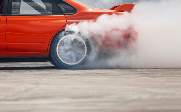 Red sports car drifting during a Chicago street takeover