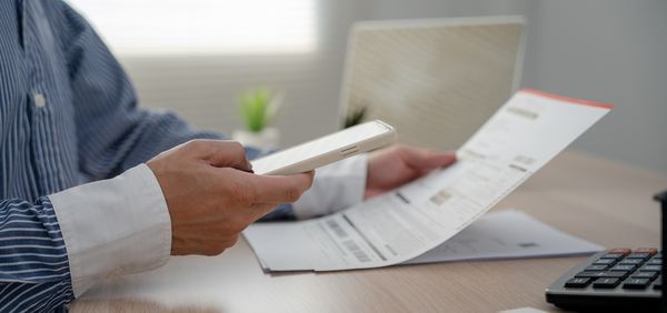 Person using their phone to take pictures of a injury release form